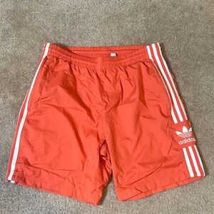 Adidas Orange Shorts with White Stripes